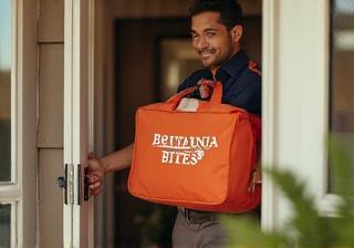 Britannia Bites courier knocking on a door